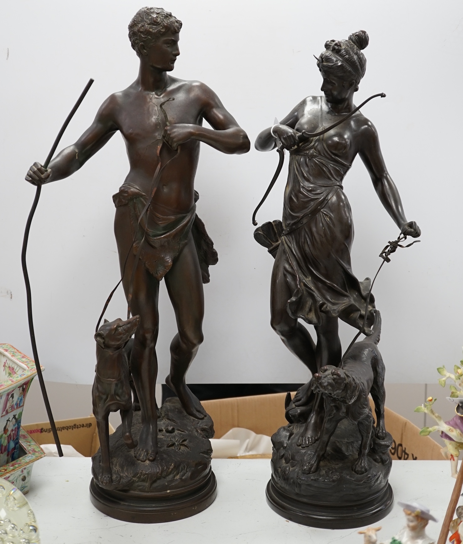 A pair of late 19th century French patinated electrotype figures of a huntsman and Diana, 72cm. Condition - poor to fair